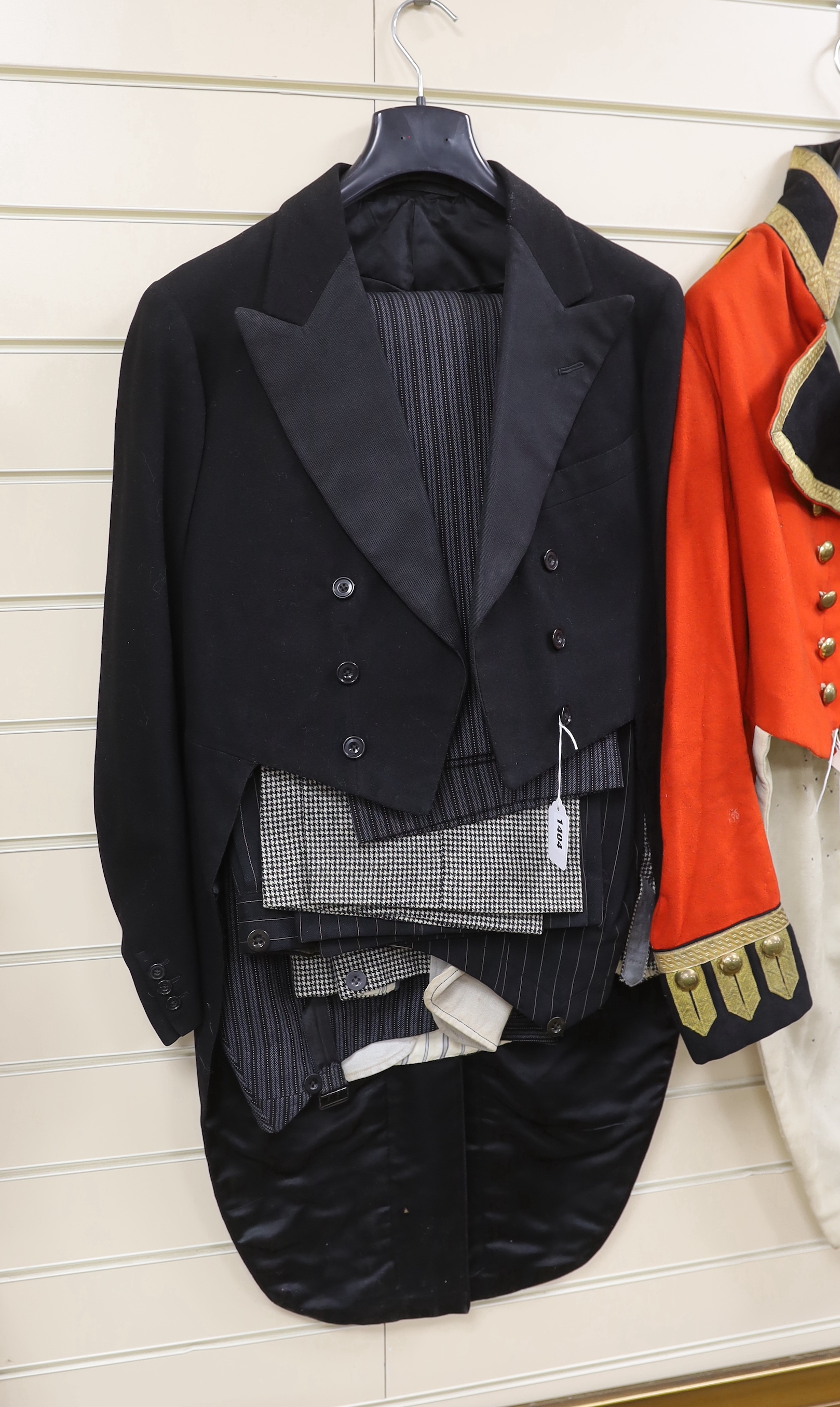 A gentleman's black tailcoat and three pairs of trousers